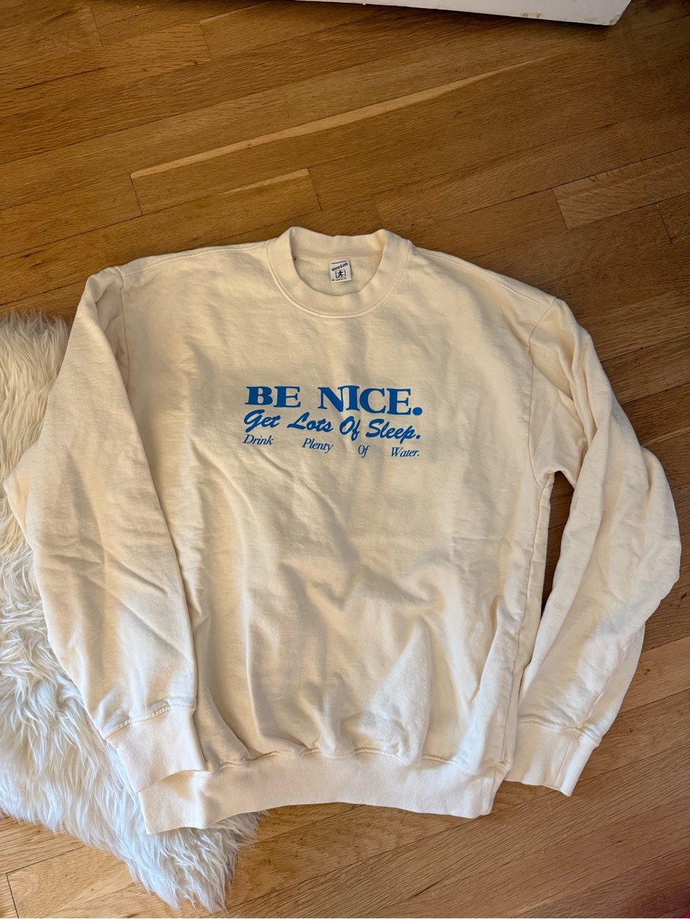 Sporty & Rich BE NICE Cream Graphic Crewneck Sweatshirt